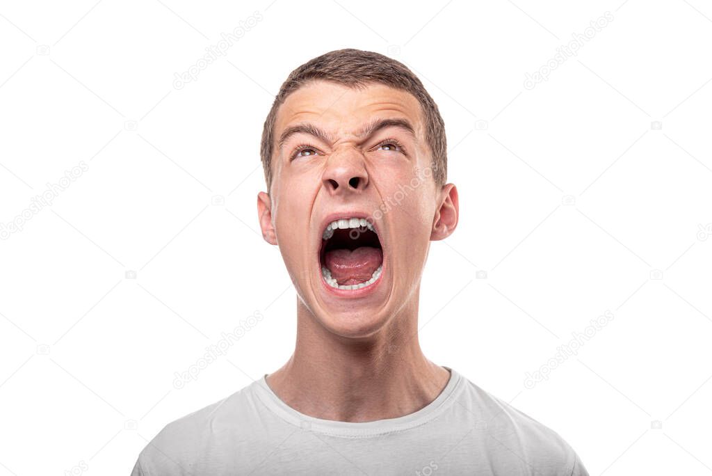 The young man shouts. Isolated on white background. Scream.