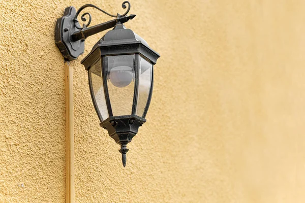 Lantern in the old style on the wall. Royalty Free Stock Images