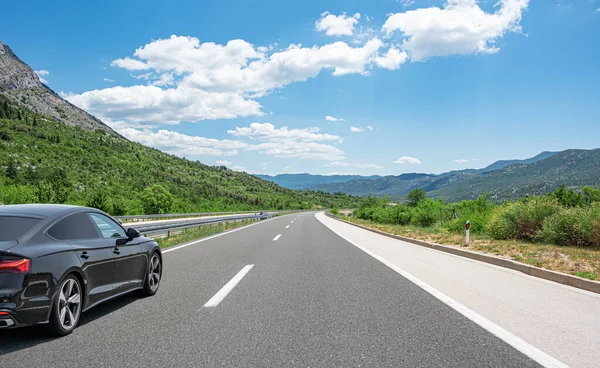 Zwarte auto op een schilderachtige weg. — Stockfoto