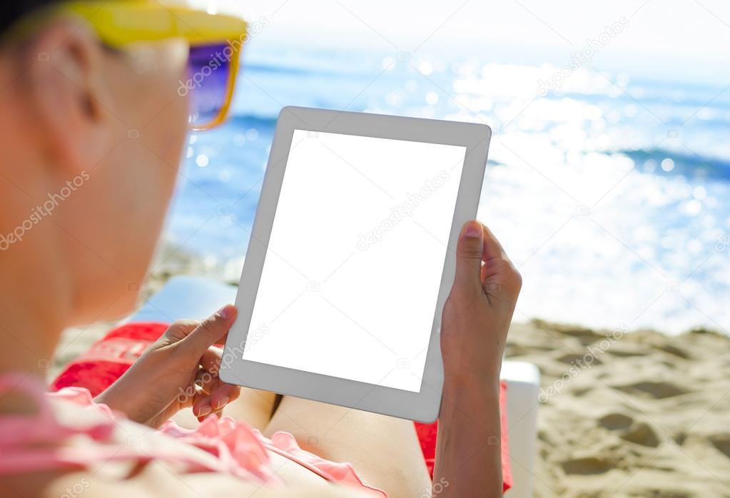 Woman with tablet pc at the beach