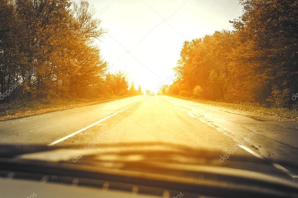 Autumn road at sunset 