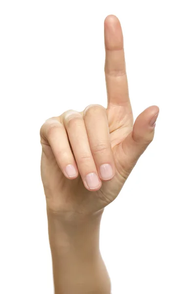 Mujer mano apuntando hacia arriba con el dedo índice — Foto de Stock