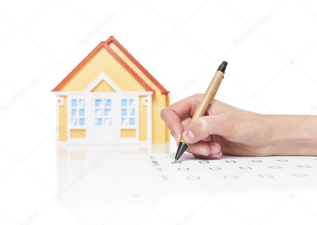 Female signing contract on a house