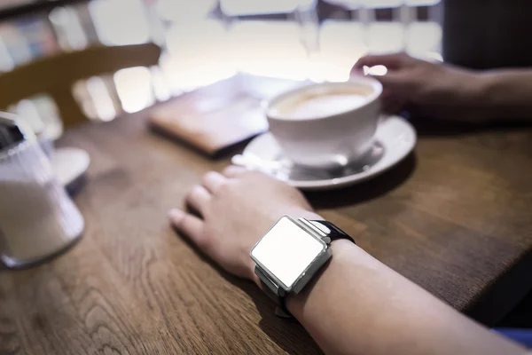 En el bar de café una mujer usando su reloj inteligente . — Foto de Stock