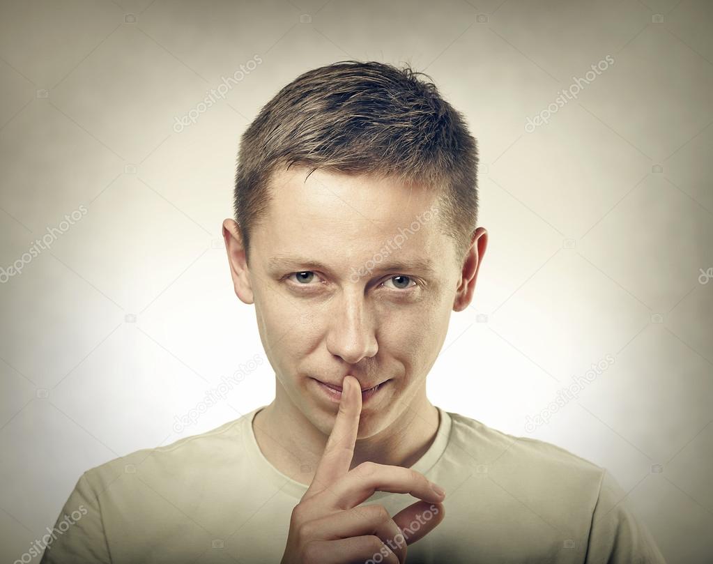 Man showing silent sign.