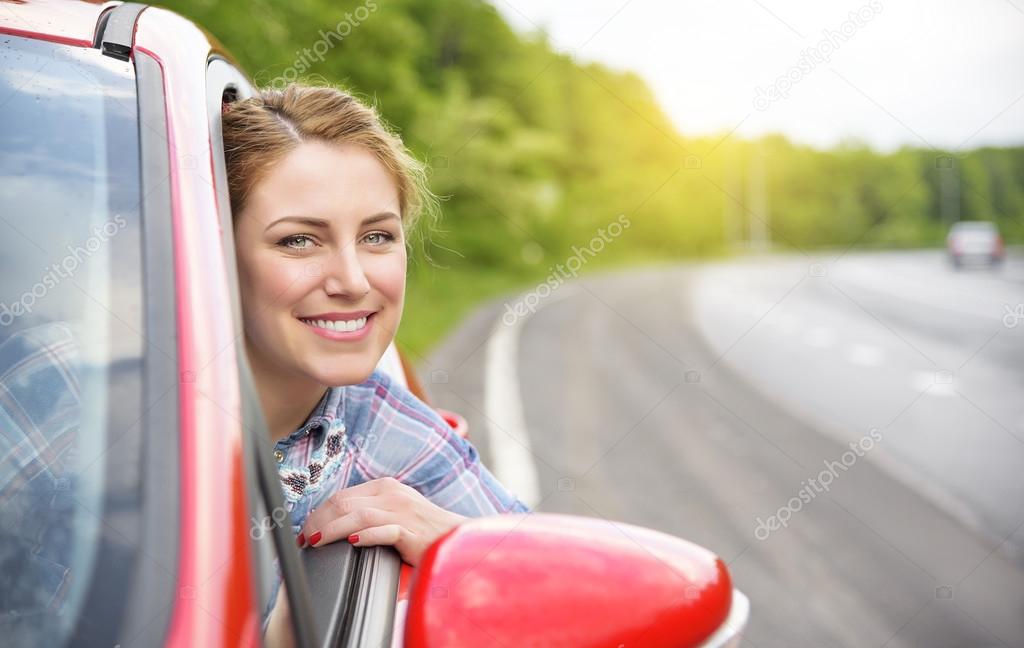 Woman in red car.