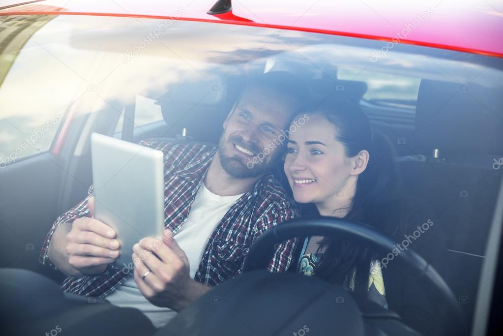 Couple using tablet in the car travel