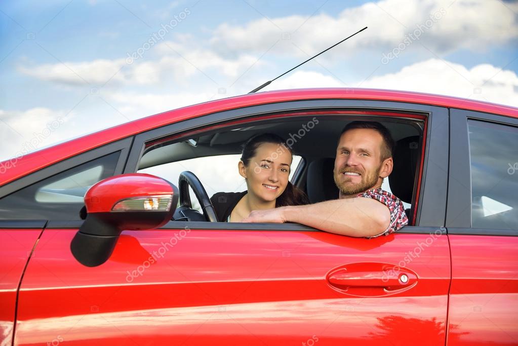 Couple in a red car