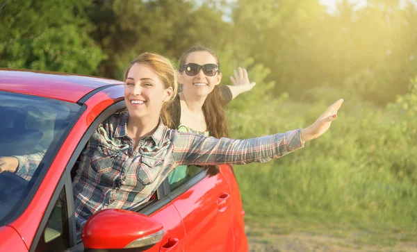 Girls in a red car. — Stock Photo, Image