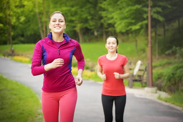 Smiling friends running outdoors. — Stock Photo, Image