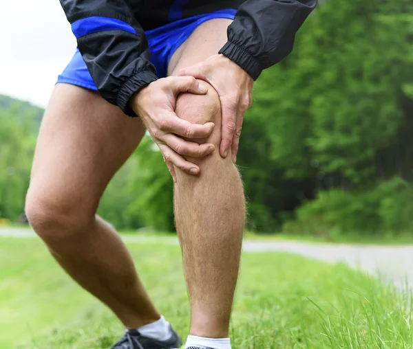 Man uit joggen met kniepijn Stockafbeelding