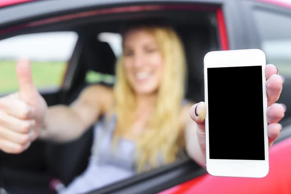 Řidič žena ukazující její smartphone. — Stock fotografie