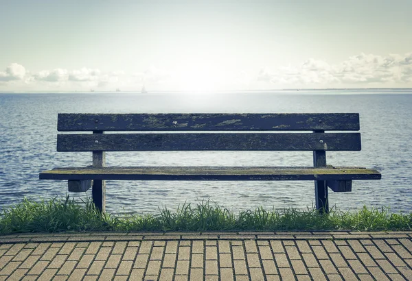 Wooden bench in front of the sea. — Stock Photo, Image