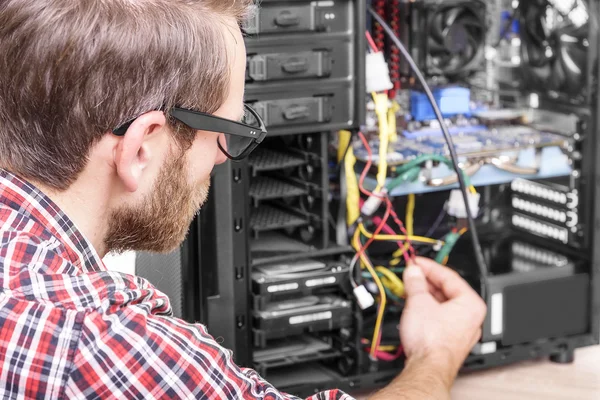 Computer engineer repairs the computer.