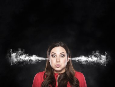 Smoke from the ears of a woman over dark background. clipart