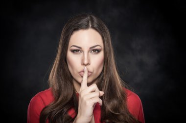Woman showing silence sign the finger near lips. clipart