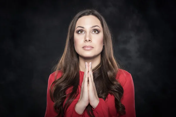 Young attractive woman praying.