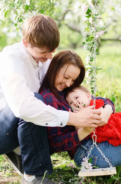 Happy family on swing — Stock Photo, Image