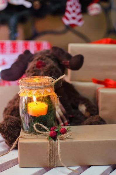 Candle on Christmas present — Stock Photo, Image