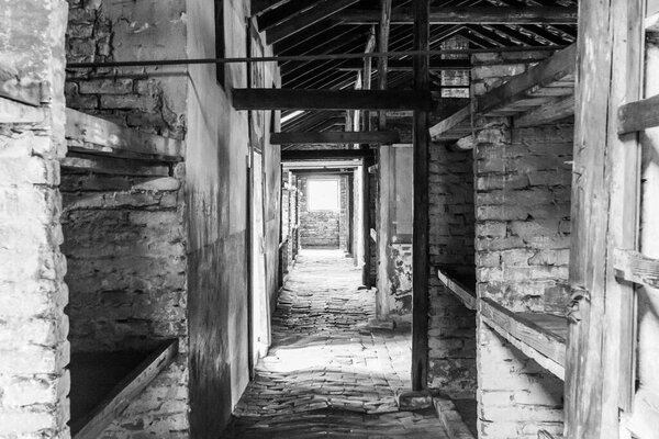 Auschwitz and Auschwitz-Birkenau, black and white photos, barracks inside.