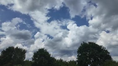 Parlak mavi gökyüzü altında hareket eden bulutların hızlandırılması, sinematik doğal hava görüntüleri