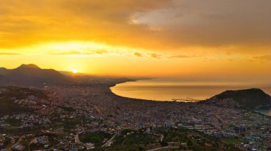 Türkiye 'nin Alanya kıyı manzarası, yüksek bir perspektiften geniş kıyı şeridi ve kentsel manzarayla altın saat içinde ele geçirildi