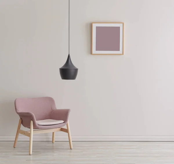 Decorative white wall, frame, pink armchair and black lamp style.