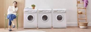 Laundry room washing machine and dirty clothes decorative modern style. Woman is waiting for the machine to finish.