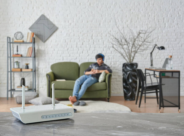 Modem and router box close up on the table style, decorative living room blue concept background.