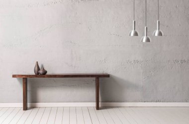 Lamba konseptli gri taş duvar, ahşap masa ve ev aksesuarı.