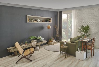 Oturma odasında gri taş duvar, yeşil koltuk, hasır sandalye, turuncu lamba ve çalışma masası, dizüstü bilgisayar ve niş. Modern iç mimari.