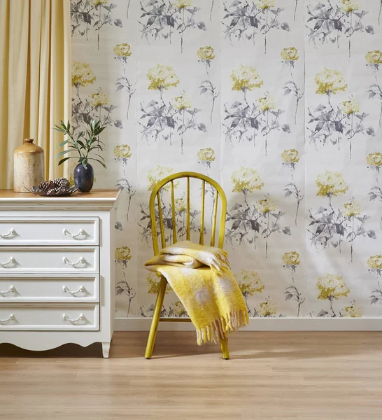 Wallpaper background in the room, wooden furniture white cabinet and chair, yellow carpet and brown parquet style.