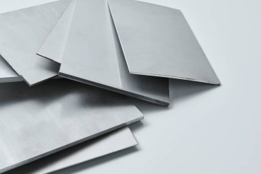 Metalik yüzey levhalarının görüntüsünü fırçalanmış ve mat bitkileriyle kapatın, mimari, imalat ve ürün tasarım uygulamaları için modern malzeme tasarımı ve endüstriyel dokular sergileniyor. İzole edilmiş beyaz arkaplan.