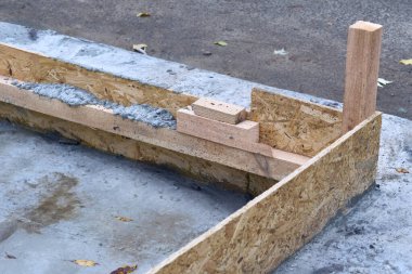 In construction, a wooden form of a future structure filled with concrete