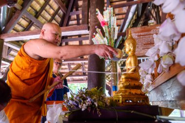 Chiang mai, Thailand - April 15, 2019 - Monks pour water over Buddha statues during the Songkran Days or traditional Thais New Year.