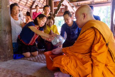 Chiang mai, Thailand - April 15, 2019 - People pour water bathing the monks during the Songkran Days or traditional Thais New Year.