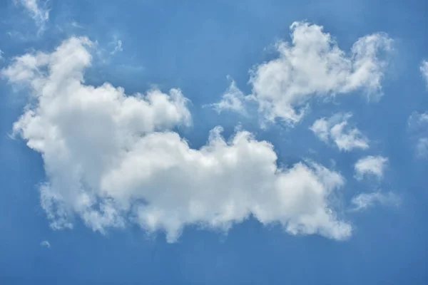 Beautiful cumulus clouds against the blue daytime sky. Cumulus is a fluffy cloud like a cotton ball.