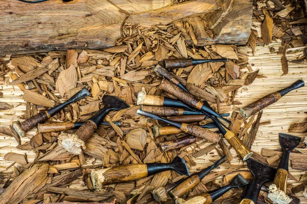 Wood carving tools arranged in an unorderly manner, carving wood in Thailand