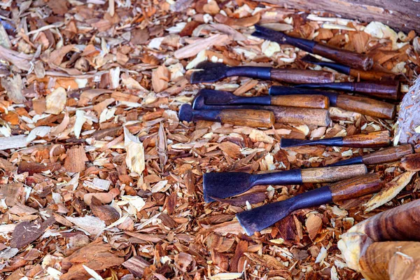 Wood carving tools arranged in an unorderly manner, carving wood in Thailand