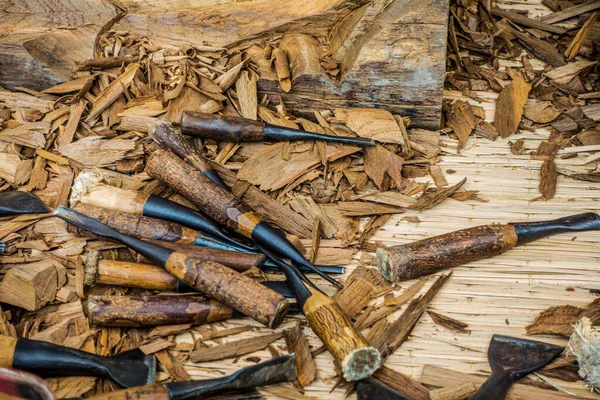 Wood carving tools arranged in an unorderly manner, carving wood in Thailand