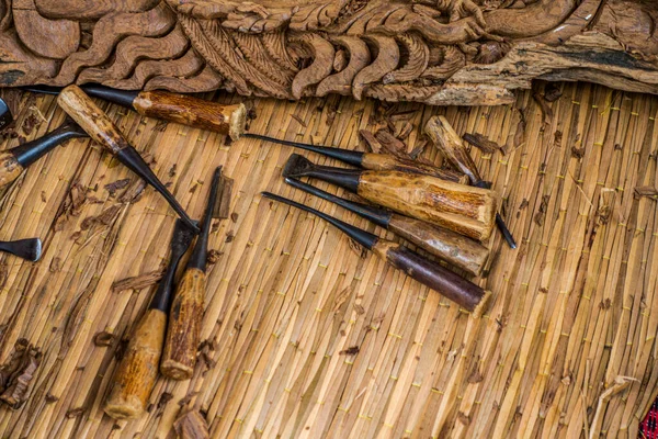 Wood carving tools arranged in an unorderly manner, carving wood in Thailand