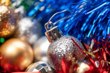 Parlak balonlar ve Noel ağacı dekorasyonunun renkli gösterişli unsurları, yakın plan, seçici odaklanma. Yeni yıl ve Noel