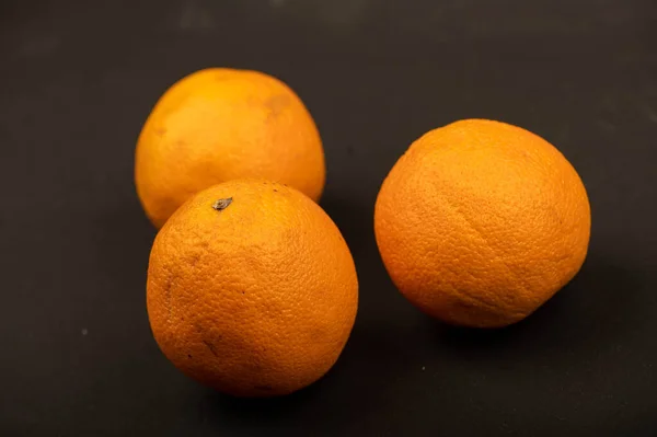 Three Fresh Juicy Oranges Black Background Close Selective Focus — Stok fotoğraf