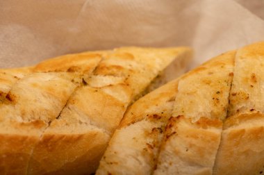 Sarımsak ezmeli baget. Parça parça kesilmiş, yakın plan, seçici odaklı.