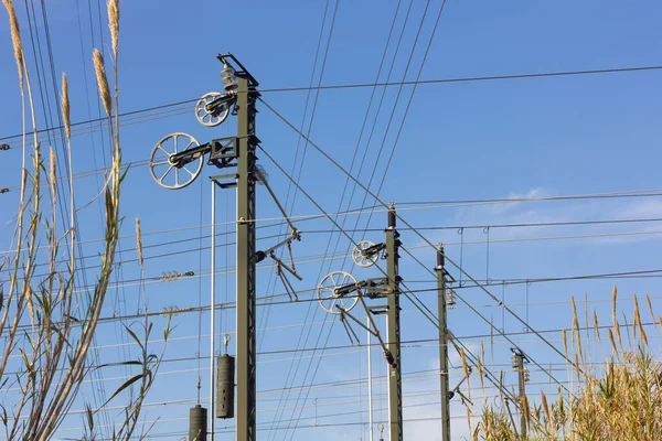 Electric catenary to supply electric power for the passage of trains. Electric cables on the train tracks.