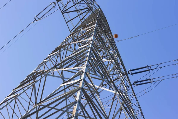 Electrical tower supporting copper cables to carry electrical energy; Engineering work to support cables carrying electricity