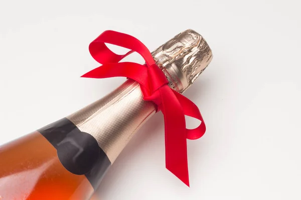 Botella Champán Con Cinta Regalo Roja Sobre Fondo Blanco Elegante — Foto de Stock