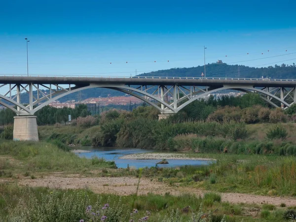Bridge with its pillars, a civil engineering work that has to support the weight of cars and trucks to cross the river.