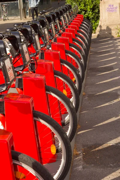 Red bicycles in the city of Barcelona. Bicycles for rent in the city.