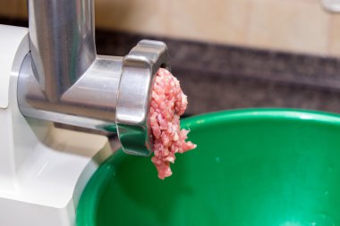 Meat grinder in the kitchen passes minced clipart